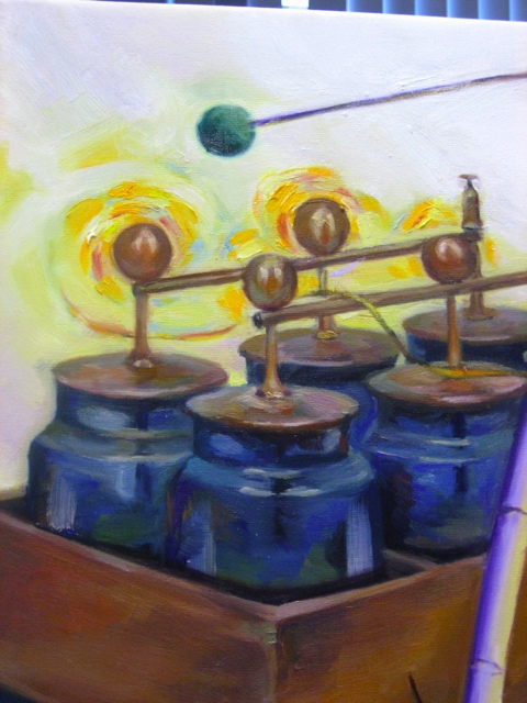 The Leiden jars pay homage to the location where the painting hangs, the Lorentz Institute, which is located in Leiden. The yellow swirls above the brass wiring charges the viewer’s attention. This yellowish region is inspired by swirling galaxies with Van Gogh flair. The green ball above the jars is the end of a pendulum. Many problems in physics reduce to solving harmonic oscillator equations.